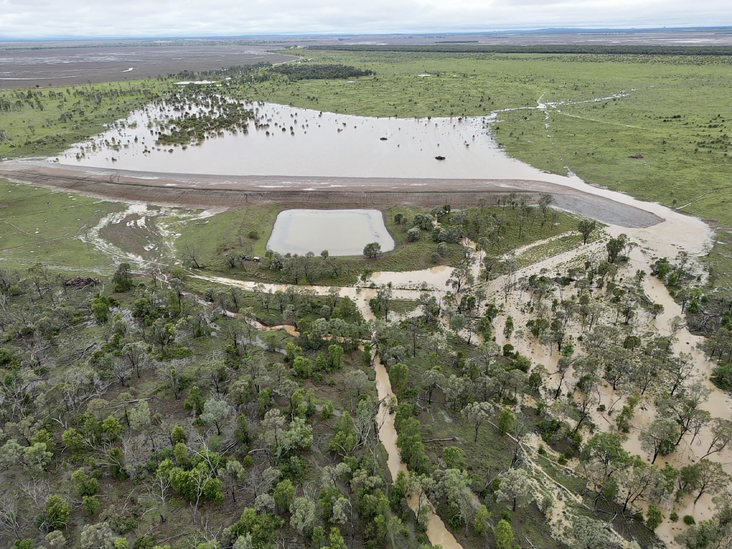 Aerial of dam and flood channel infrastructure built by HE Earthmoving in Queensland