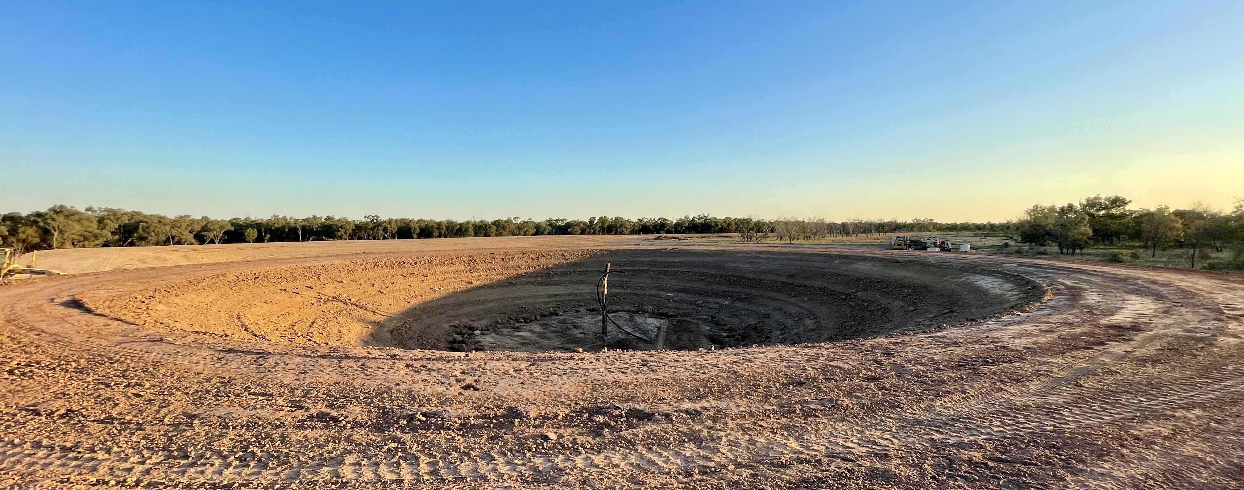 Large dam construction panorama at golden hour in Central Queensland