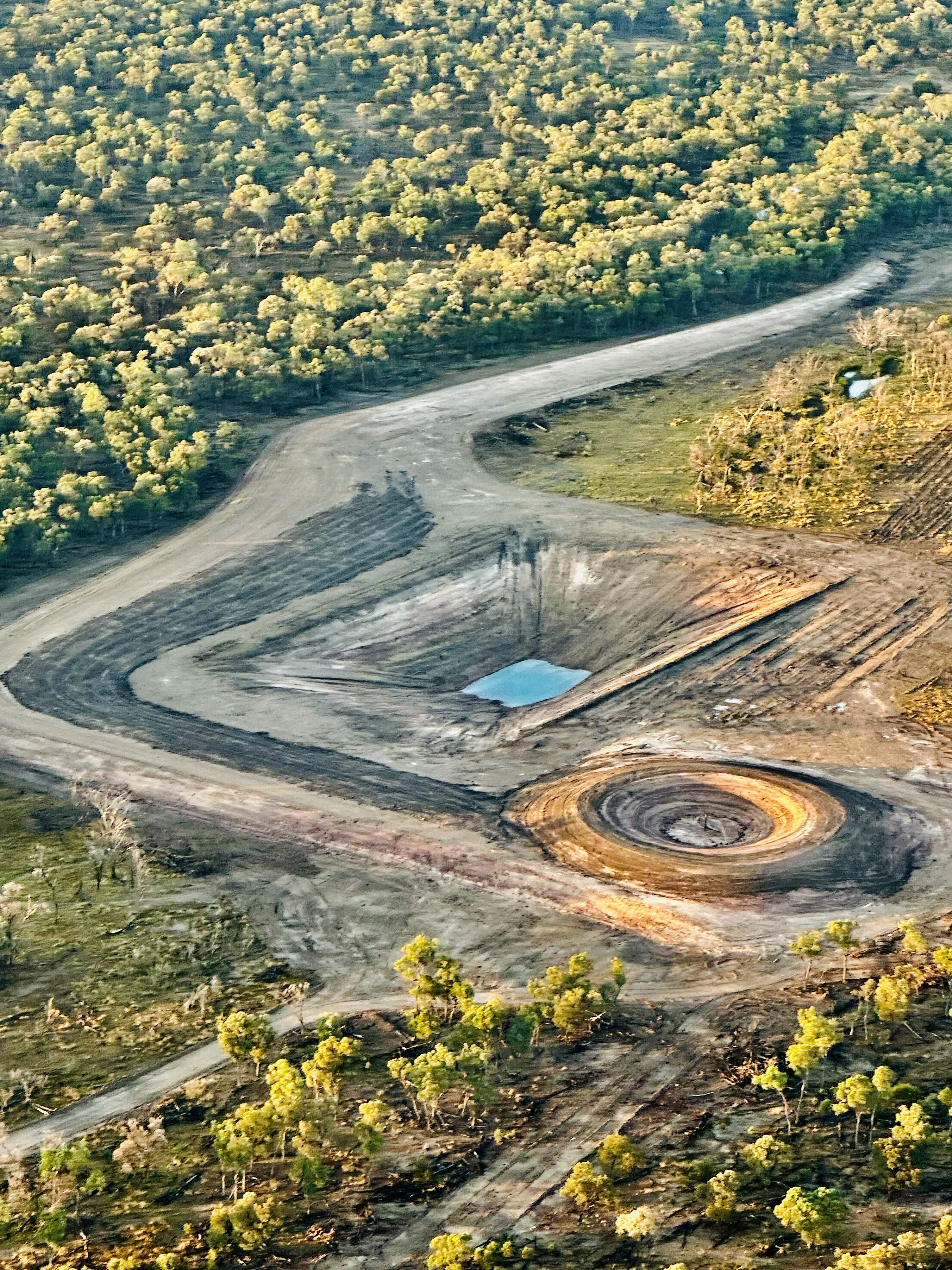 Aerial view of completed dam with water storage built by HE Earthmoving in Queensland