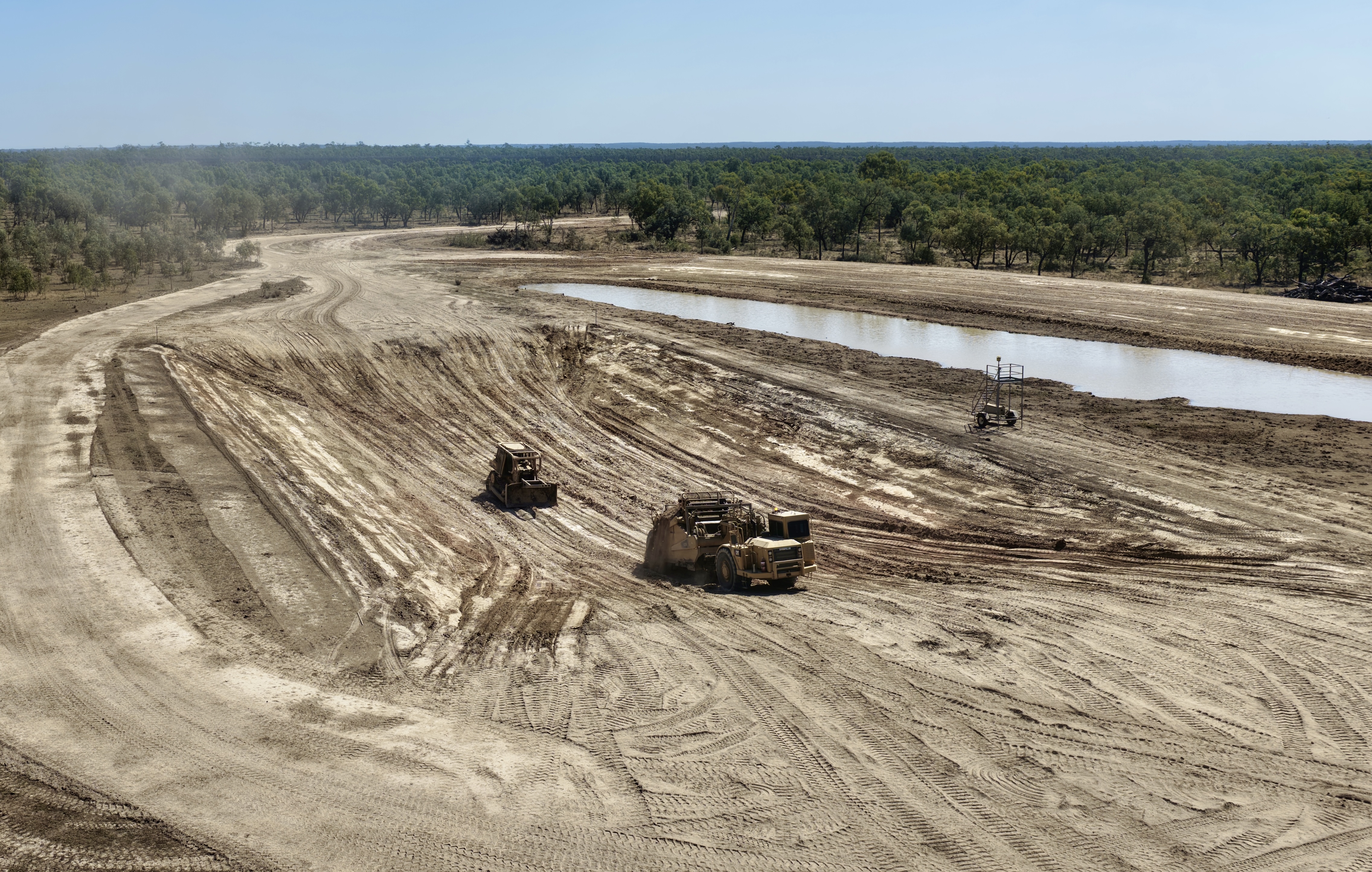 Dam construction in progress with earthmoving machinery, aerial view in Central Queensland